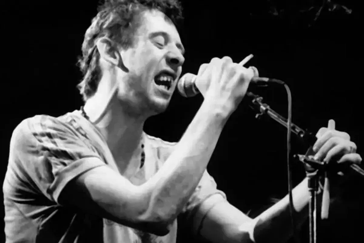 Shane MacGowan singing with intense expression