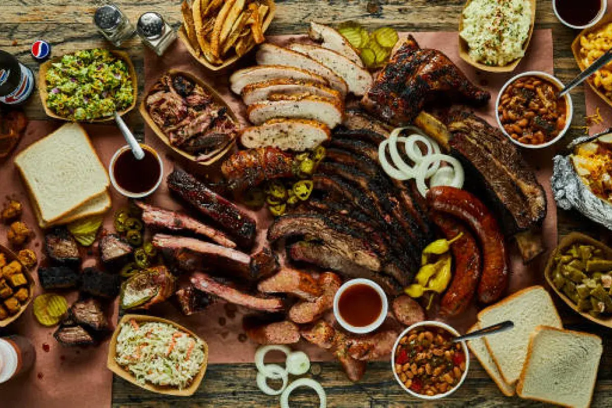 Oversized Texas barbecue meal served on a large wooden board