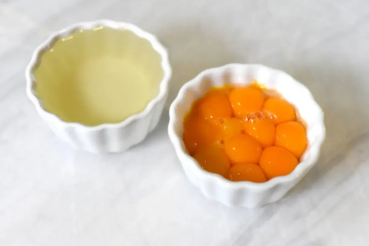 Egg yolks and whites separated for baking preparation.
