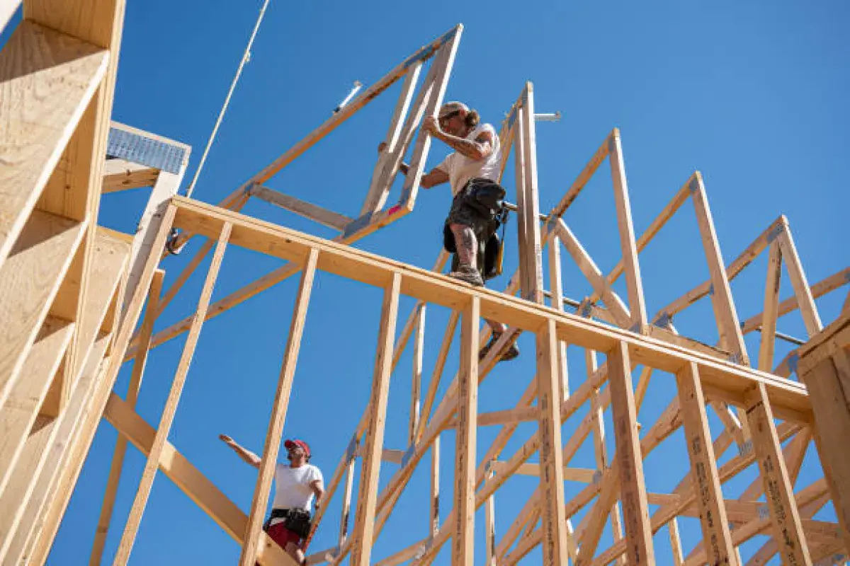 Construction crew framing a wooden residential structure