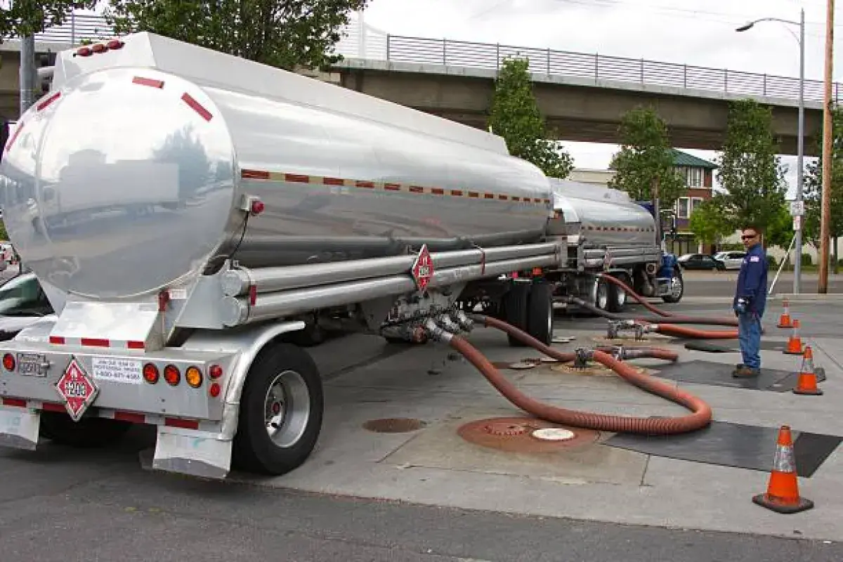 Fuel tanker trucks delivering gasoline to distribution terminals.