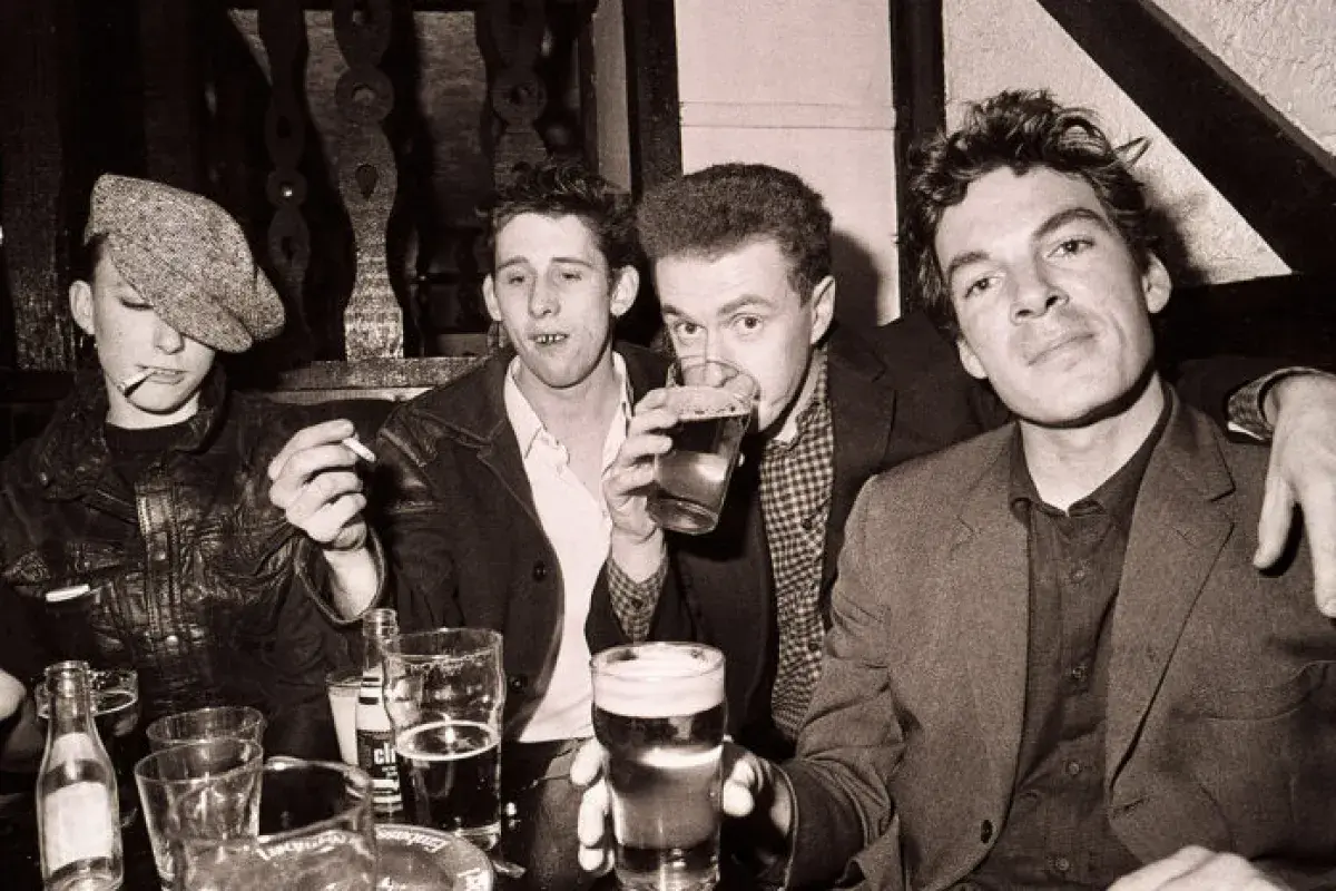 Early era photo of The Pogues in a raw and energetic setting