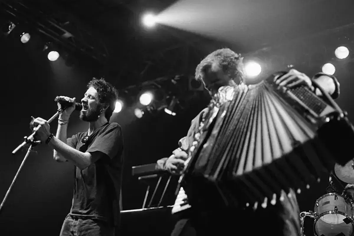 Tin whistle and accordion illuminated on stage