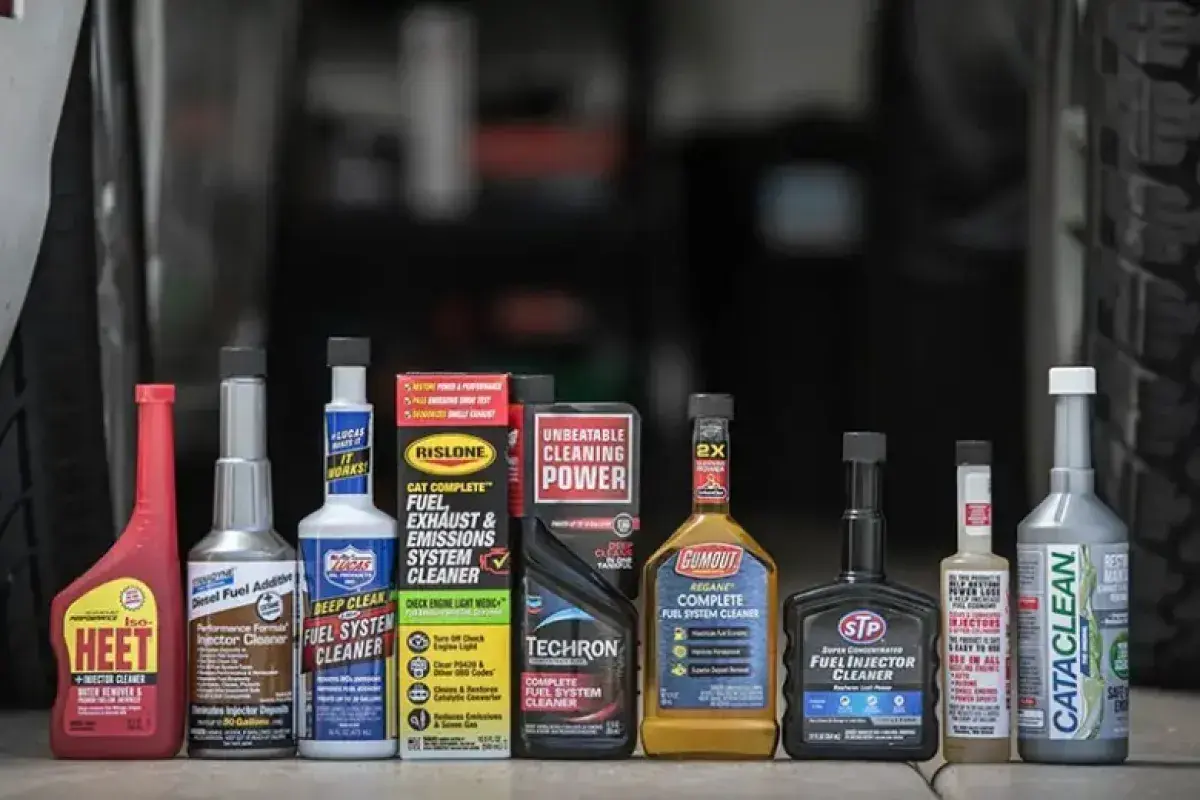 Fuel additive product on a table with a car behind