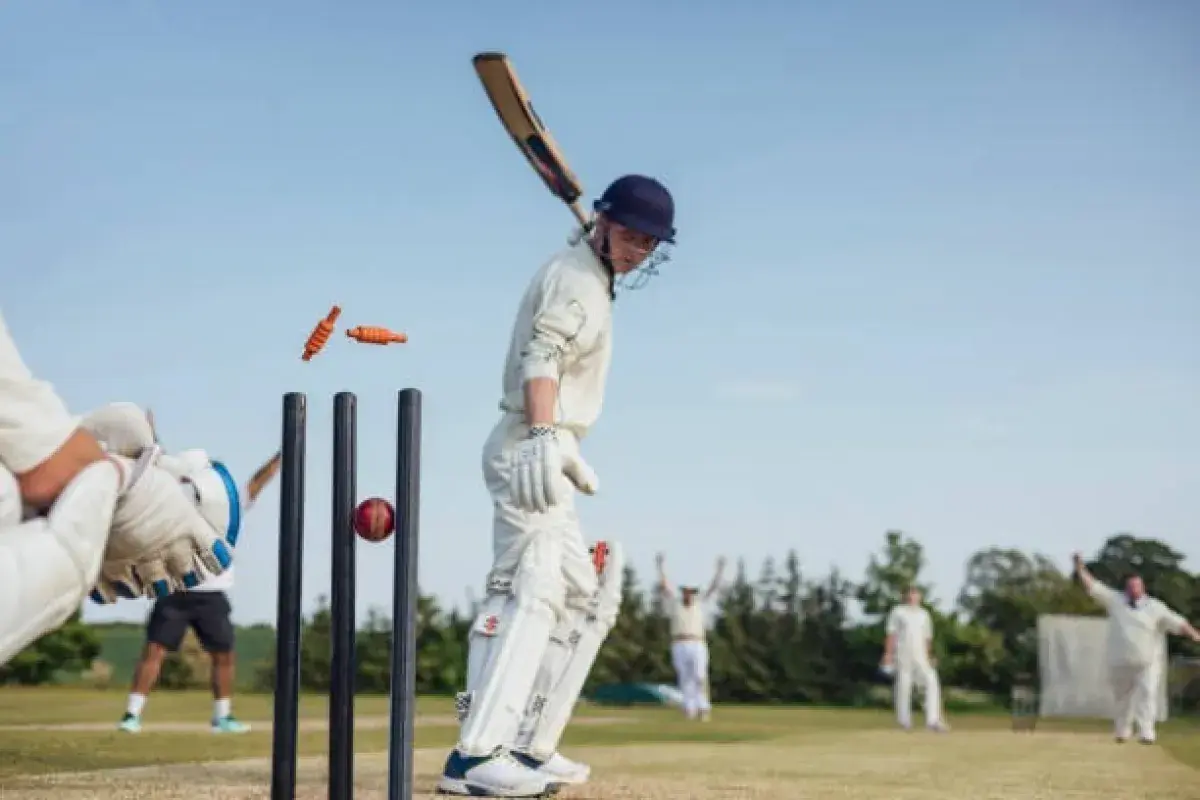 Cricket batsman hitting ball in packed international cricket stadium