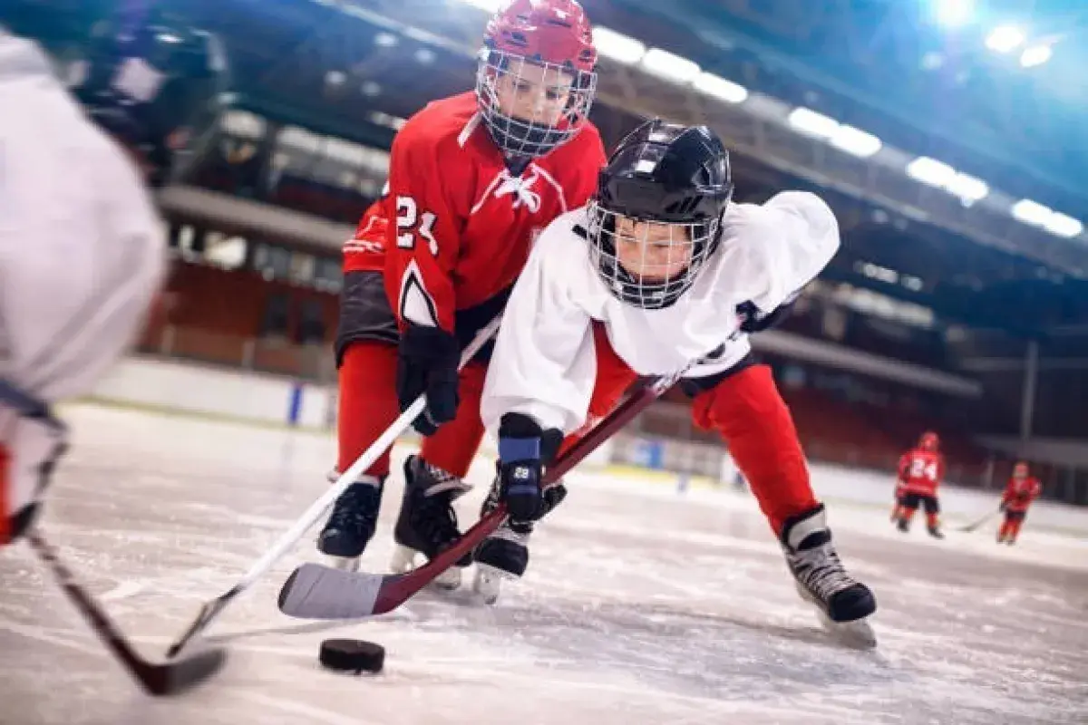Ice hockey forward firing shot toward goal during professional hockey game