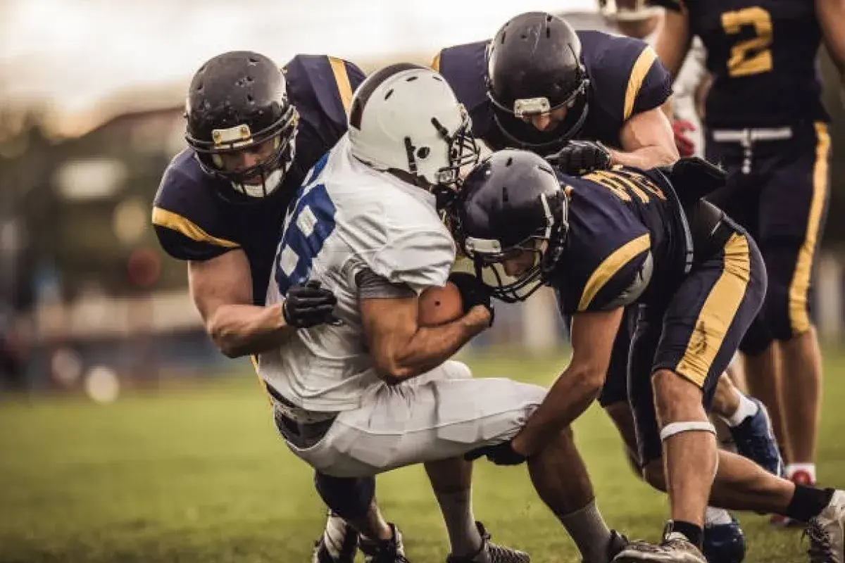American football quarterback preparing to throw under defensive pressure