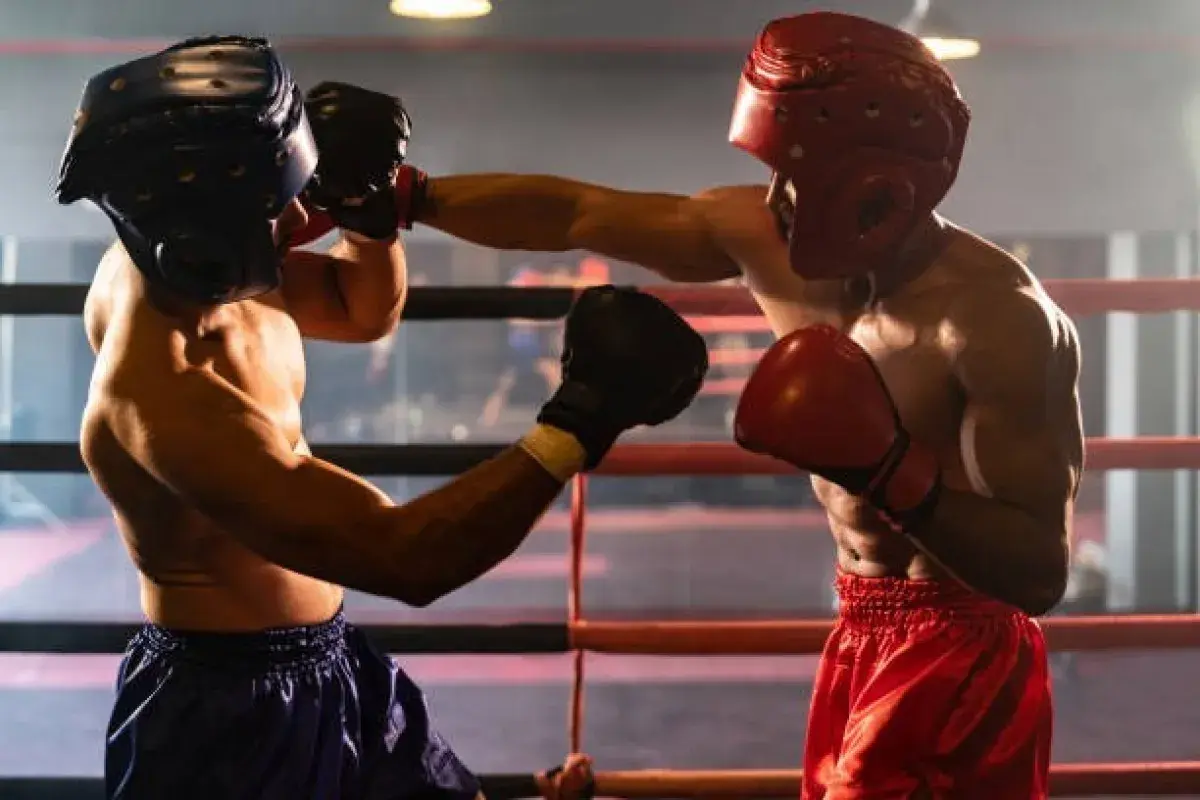 Professional boxers exchanging punches inside boxing ring before roaring crowd