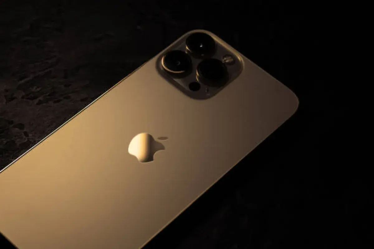 Gold iPhone shining under soft light