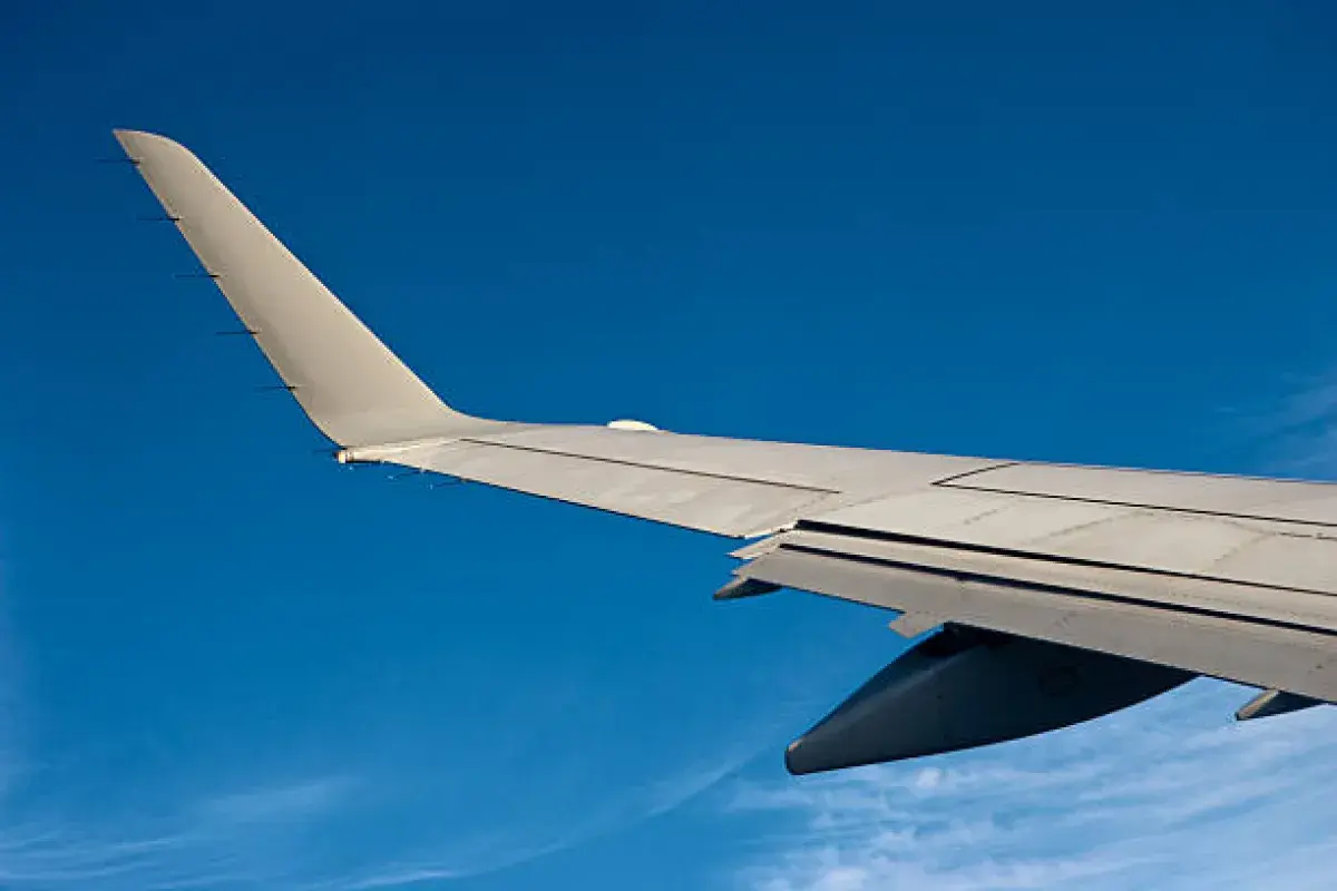 Airplane wing bending upward in flight