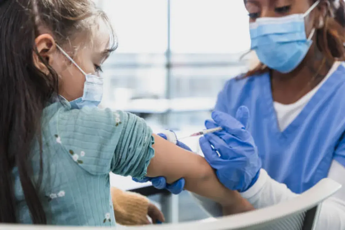 Healthcare workers administering vaccines in a community clinic