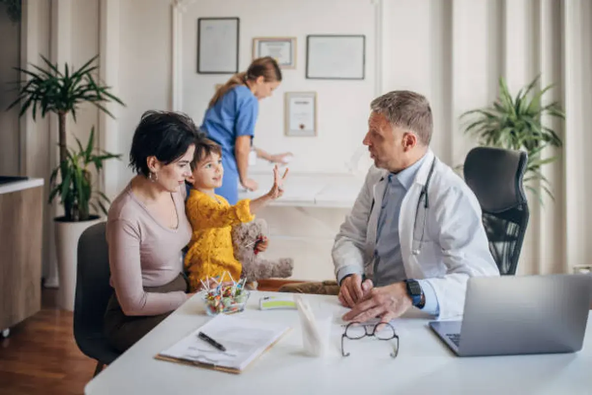 Pediatrician discussing vaccine safety with parents