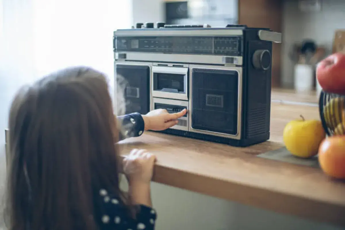 Recording a favorite song from the radio on a cassette tape