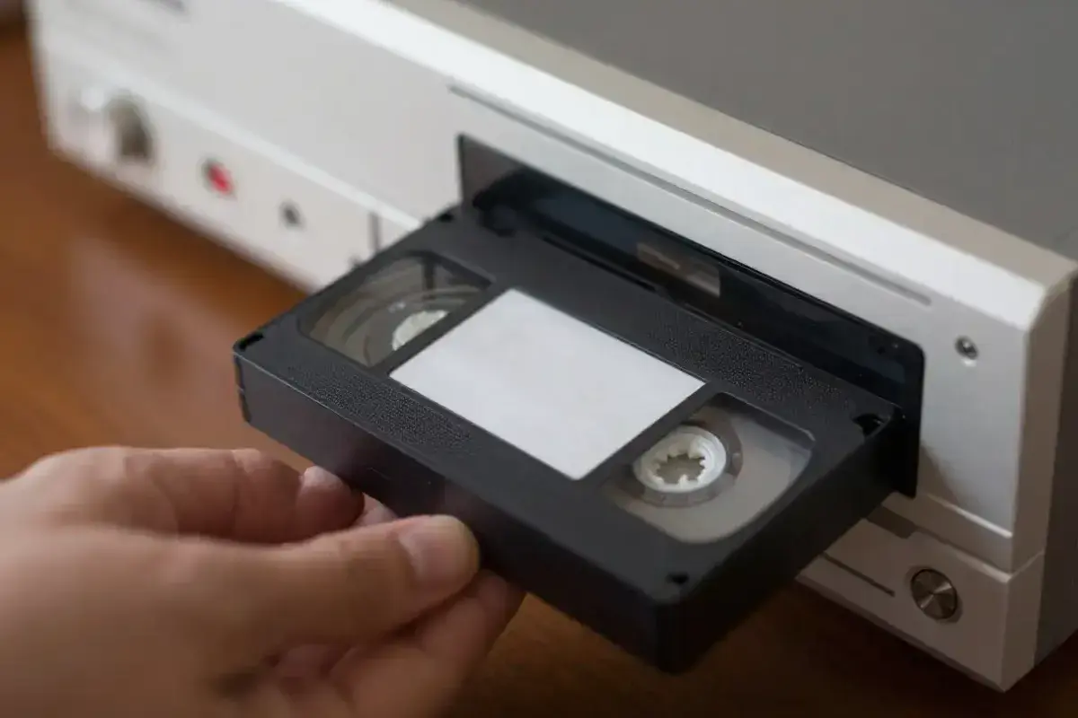 Classic VHS cassette tape being inserted into a home VCR
