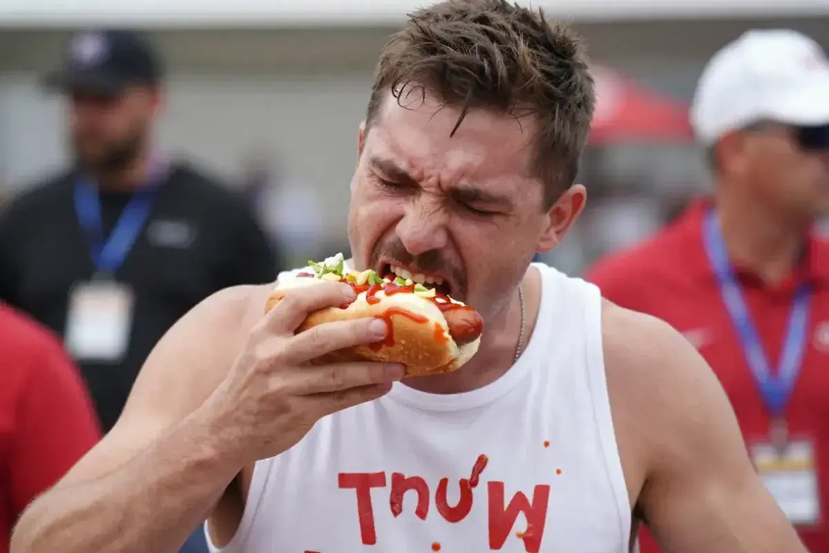 Competitive eater participating in a major hot dog eating contest