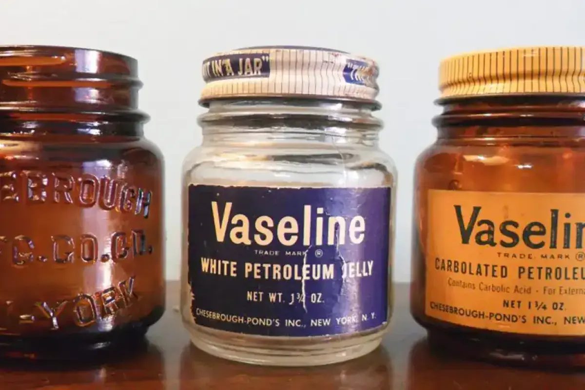 Display of antique Vaseline jars in a museum exhibit