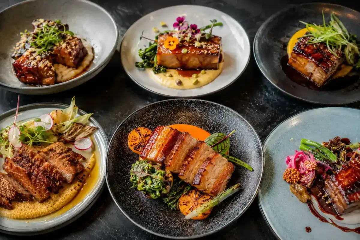 Creative gourmet pork belly dishes with colorful garnishes