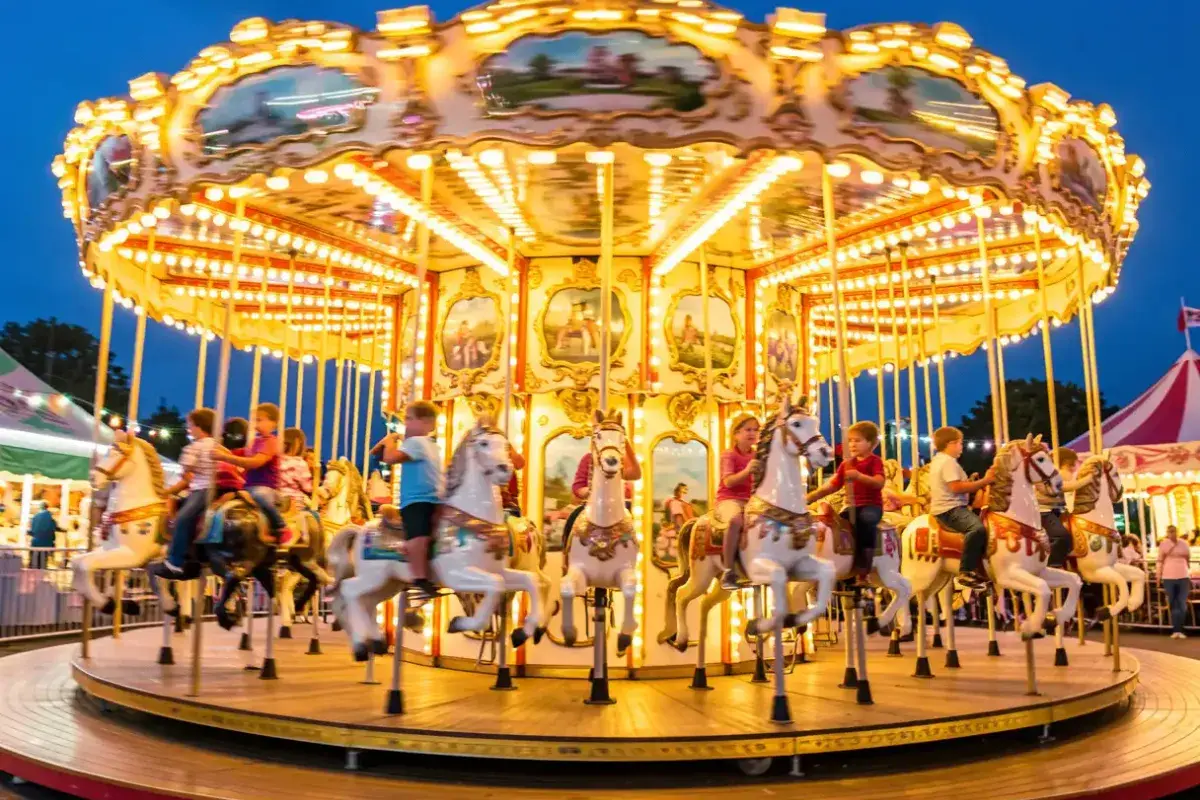 A colorful, spinning vintage carousel with detailed horses and bright lights