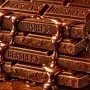 Classic Hershey chocolate bars stacked with rich melted texture