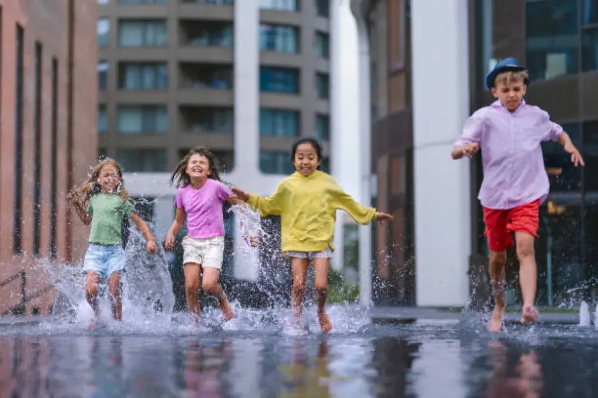 Children playing in the rain representing innocence and unfiltered joy.