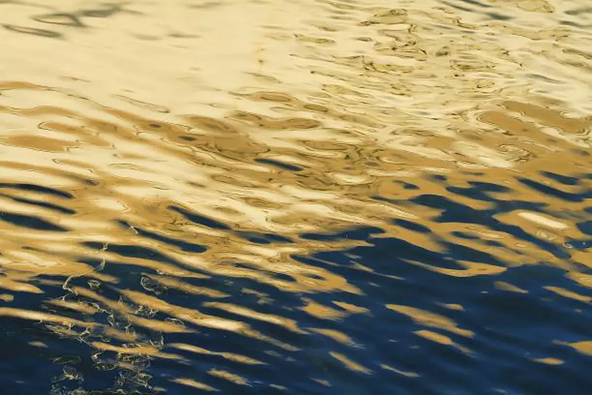 Reflections of light and darkness on moving water representing the inner emotional landscape