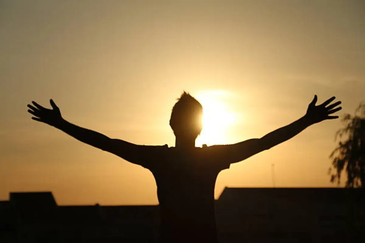 Hands lifted toward the sky representing openness to God’s presence