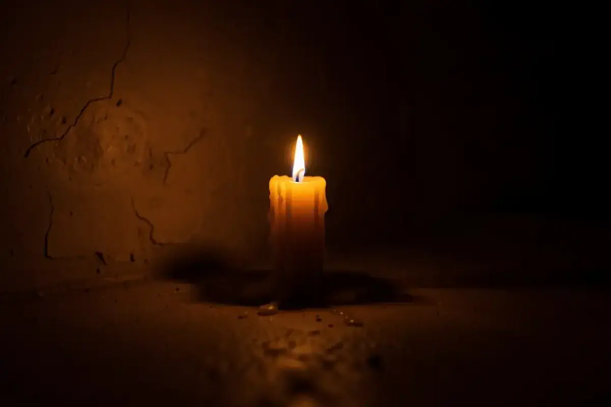  A single candle burning in a dark room
