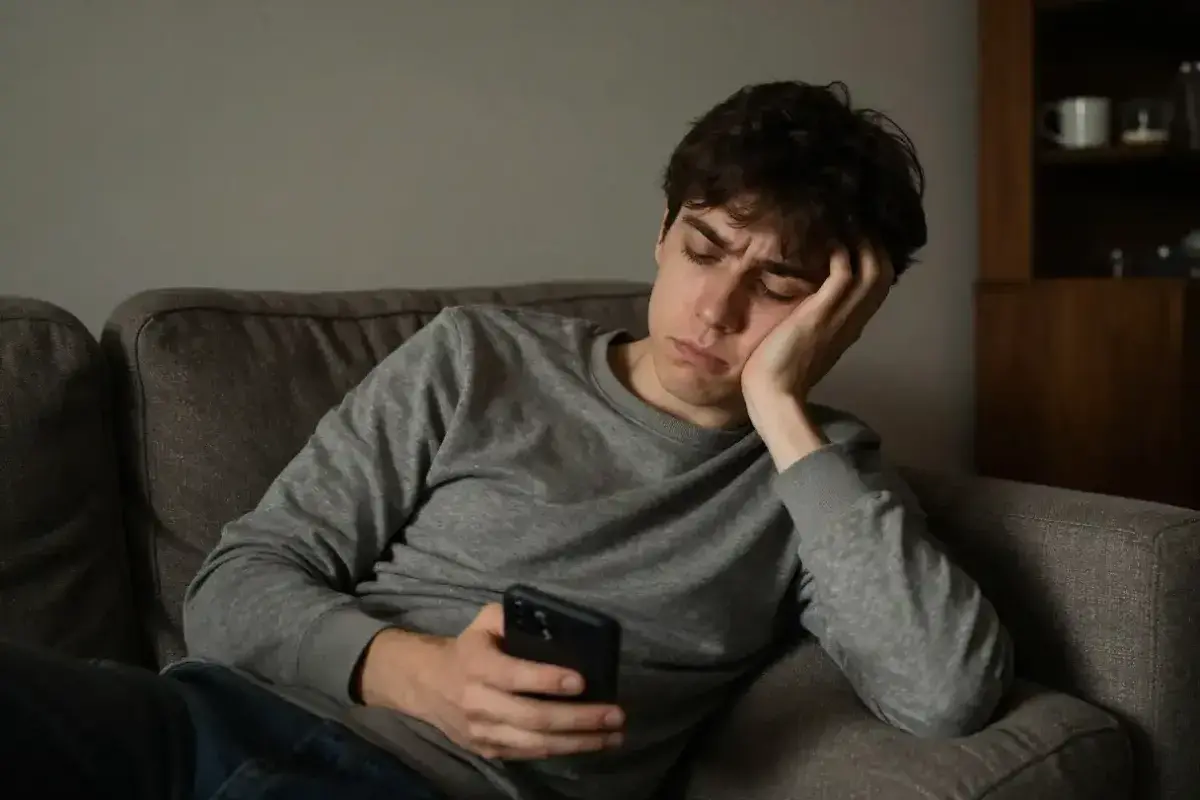 Individual appearing disengaged while scrolling on smartphone