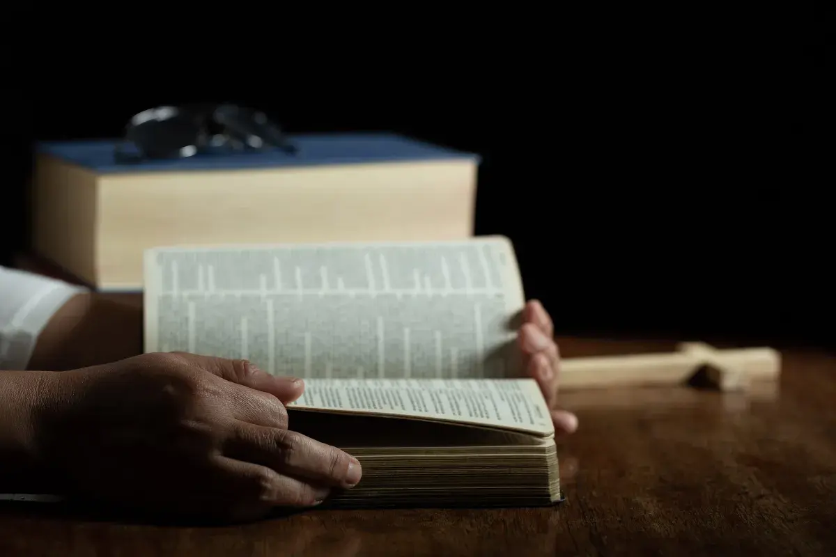 bible wtih hands