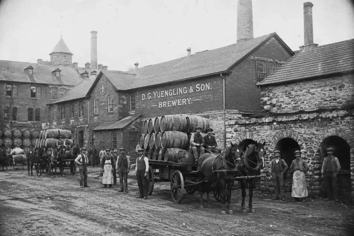 Historic brewery yard with horse drawn wagons in the 1800s