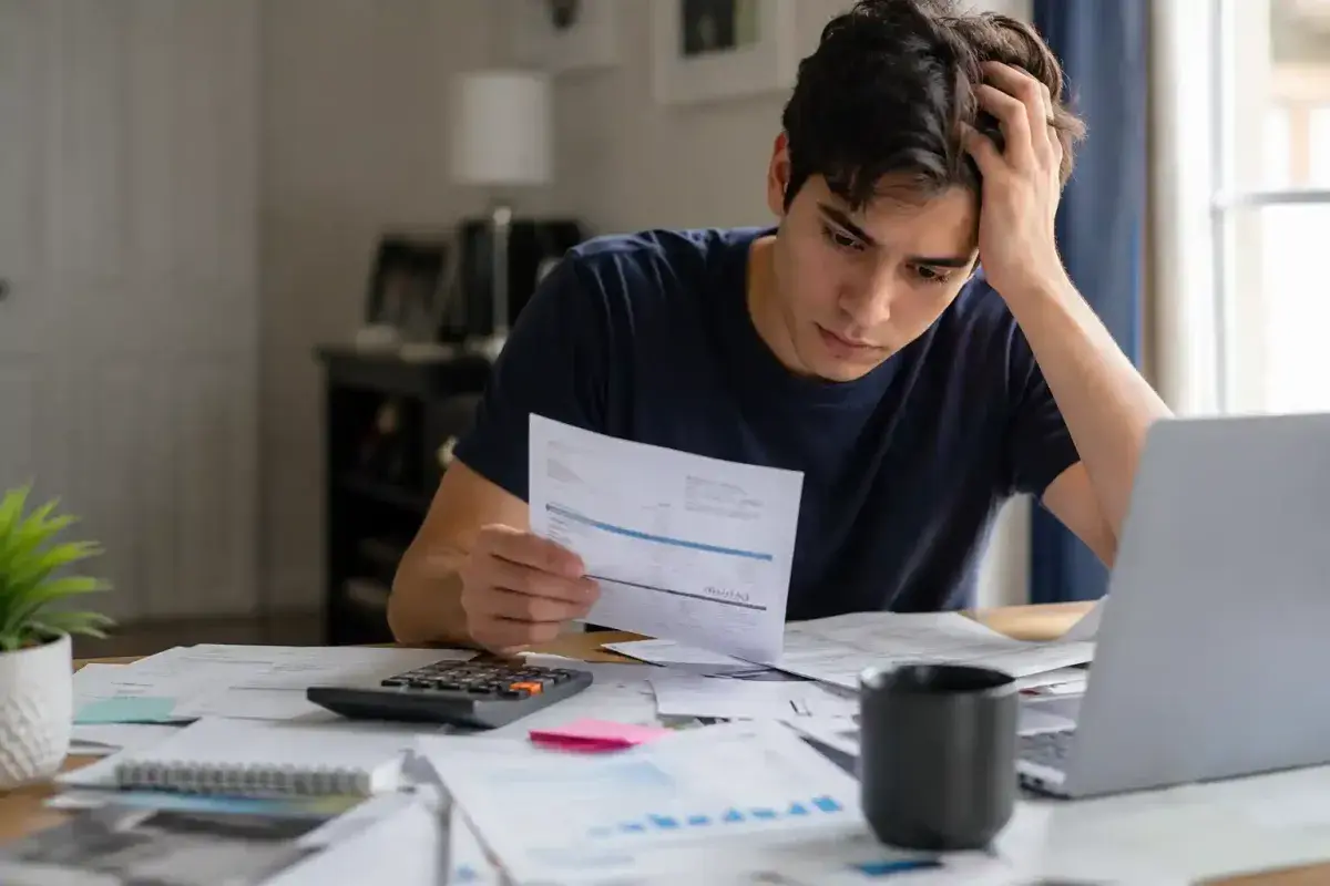 Young adult learning everyday responsibilities such as budgeting and home repair