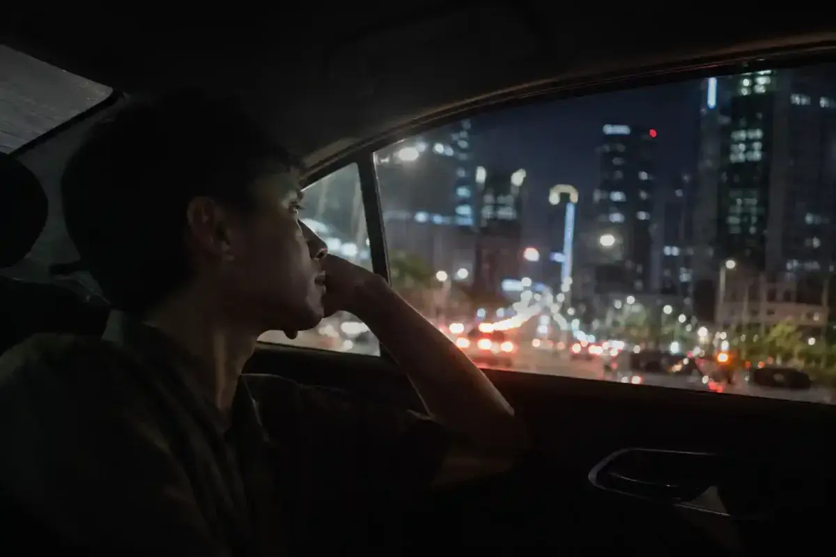 A person reflecting during a life changing taxi ride