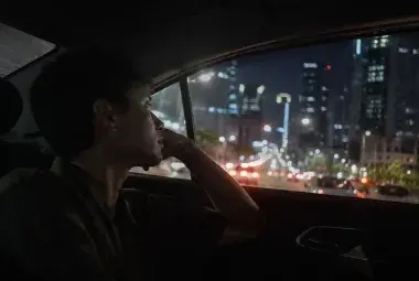 A person reflecting during a life changing taxi ride
