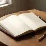 Open leather journal and fountain pen on a sunlit wooden desk, ready for writing