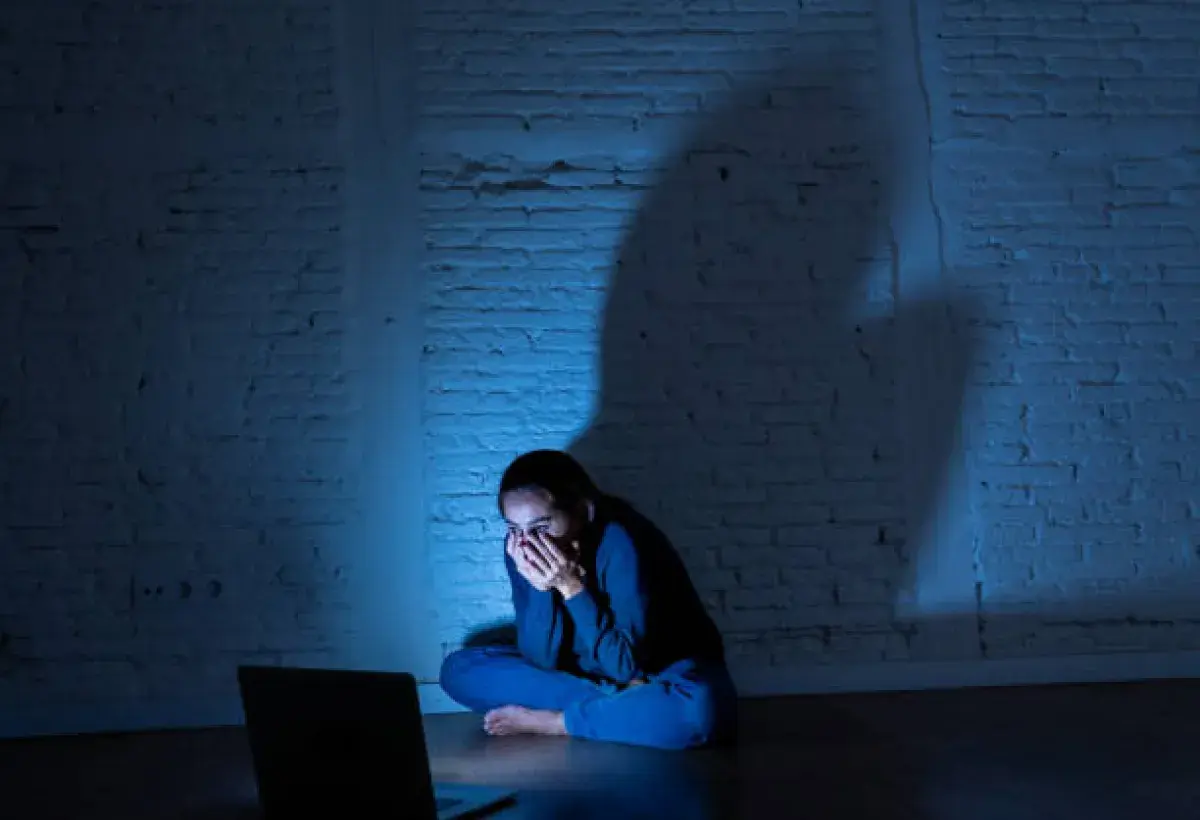 Individual overwhelmed by the negative effects of a viral video