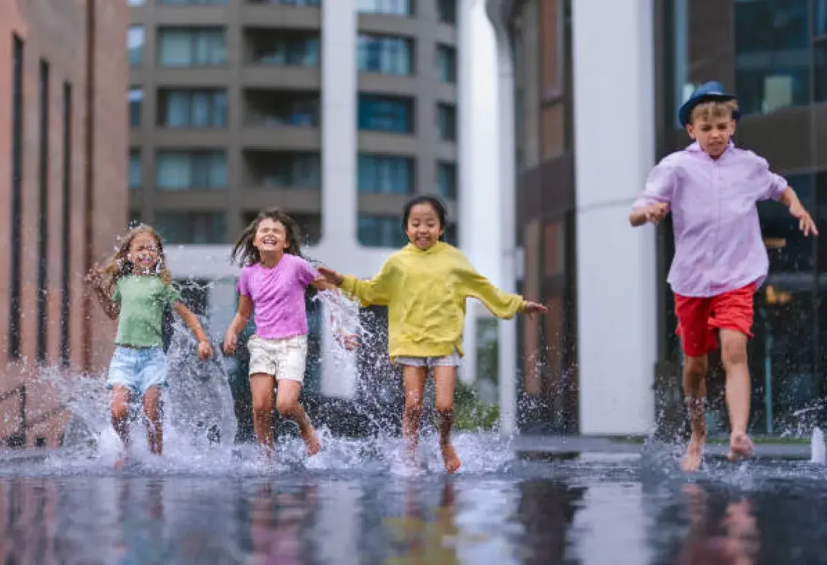 Children playing in the rain representing innocence and unfiltered joy.