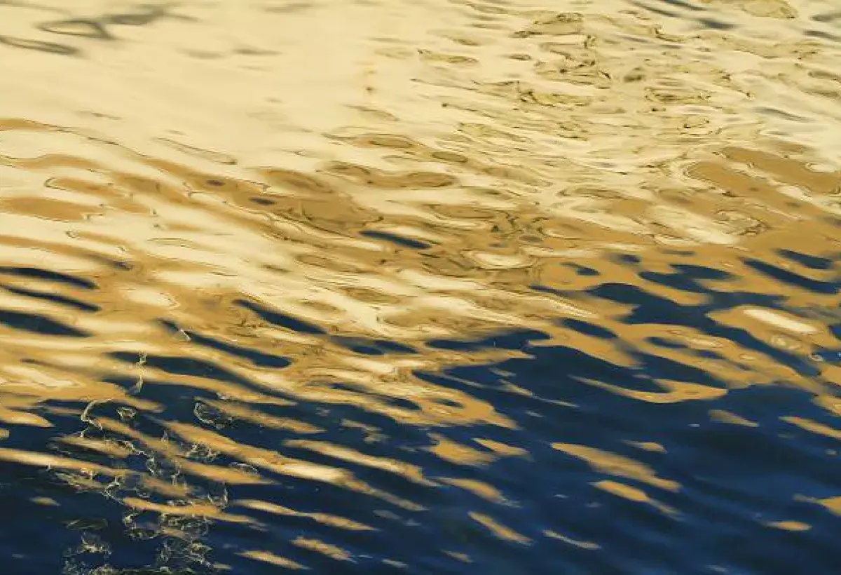 Reflections of light and darkness on moving water representing the inner emotional landscape