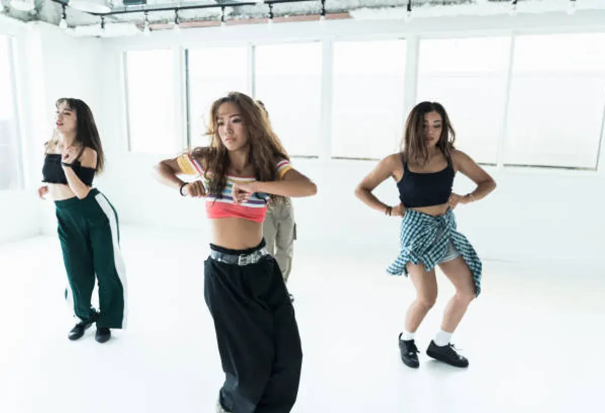 Professional choreographer guiding K-pop group during rehearsal
