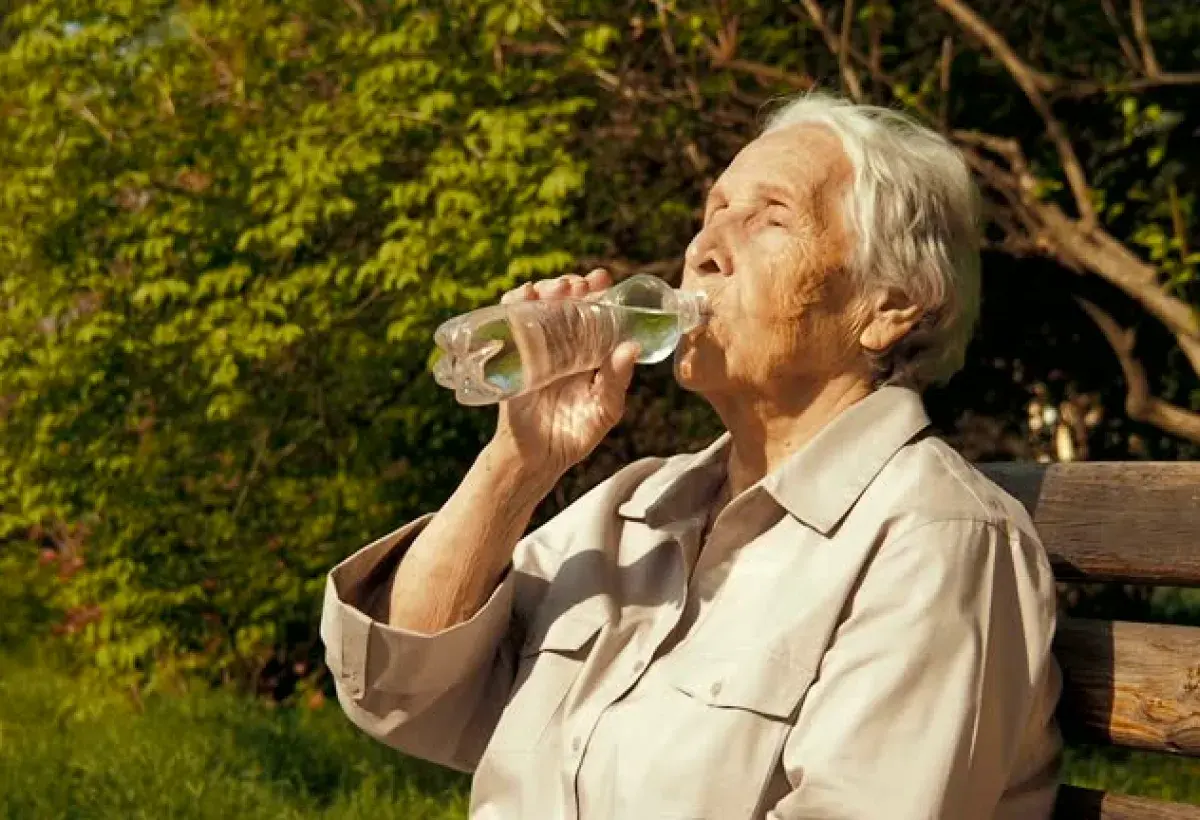 Nicoyan centenarian drinking mineral-rich water at sunrise, Nicoya Peninsula, Costa Rica