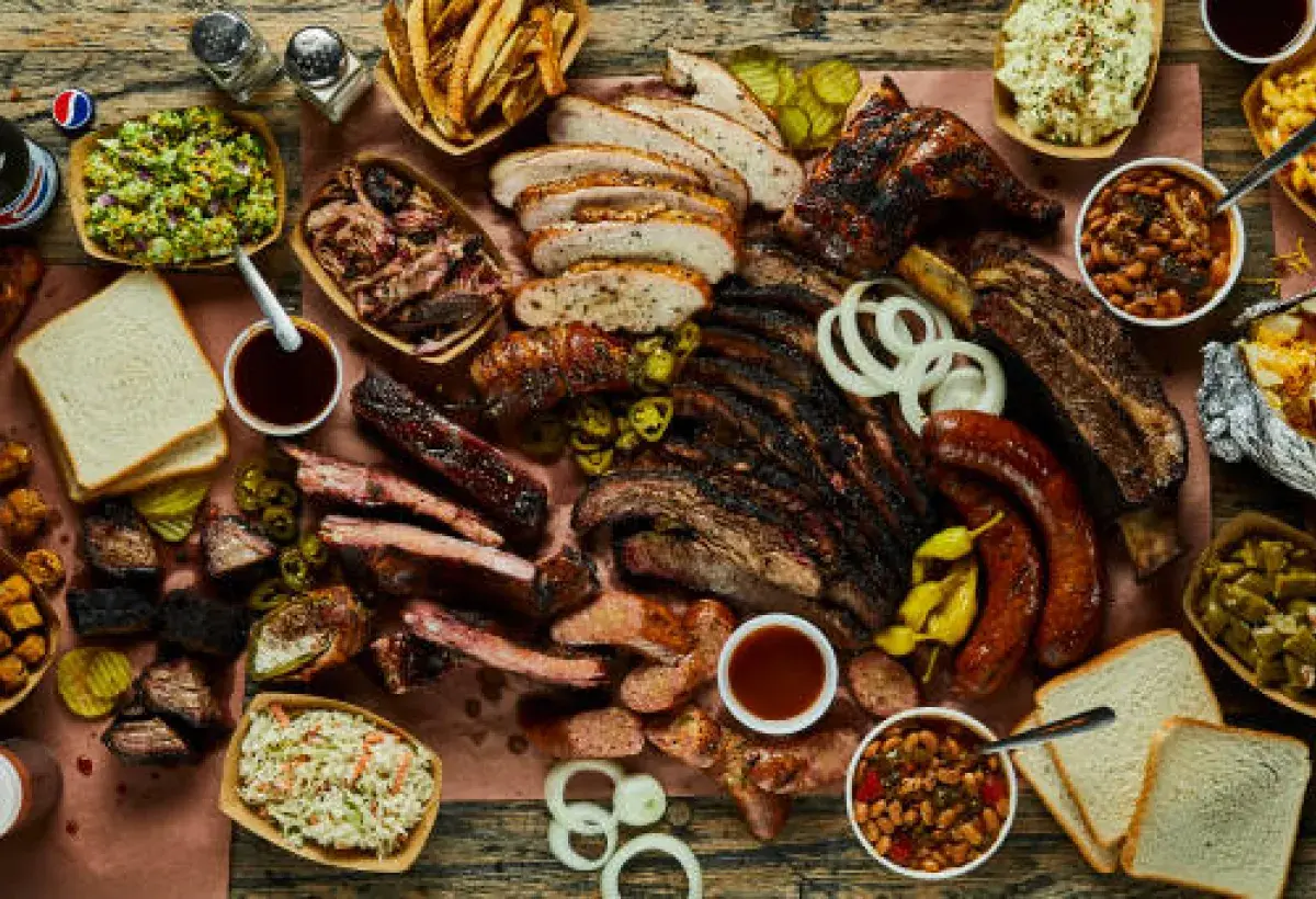 Oversized Texas barbecue meal served on a large wooden board