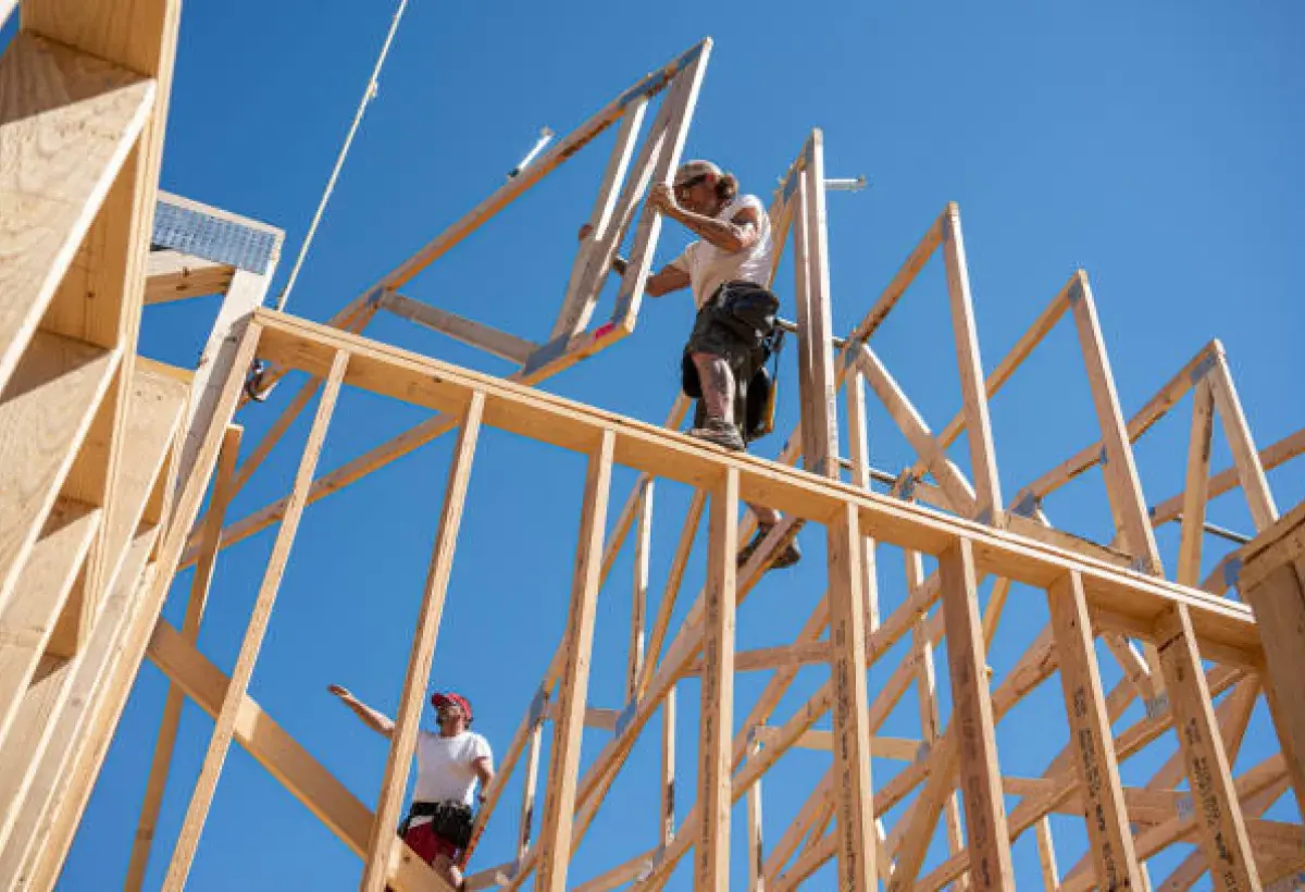 Construction crew framing a wooden residential structure