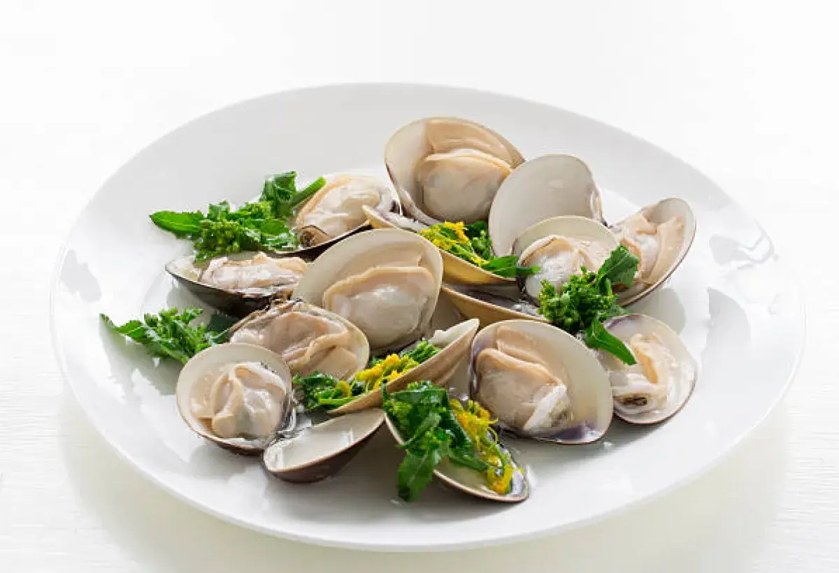 Steamed little neck clams served with fresh herbs and lemon