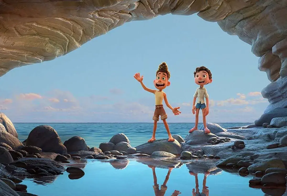 Luca and Alberto laughing together while looking at the sea