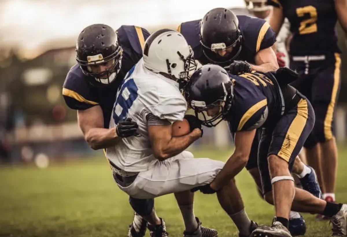 American football quarterback preparing to throw under defensive pressure