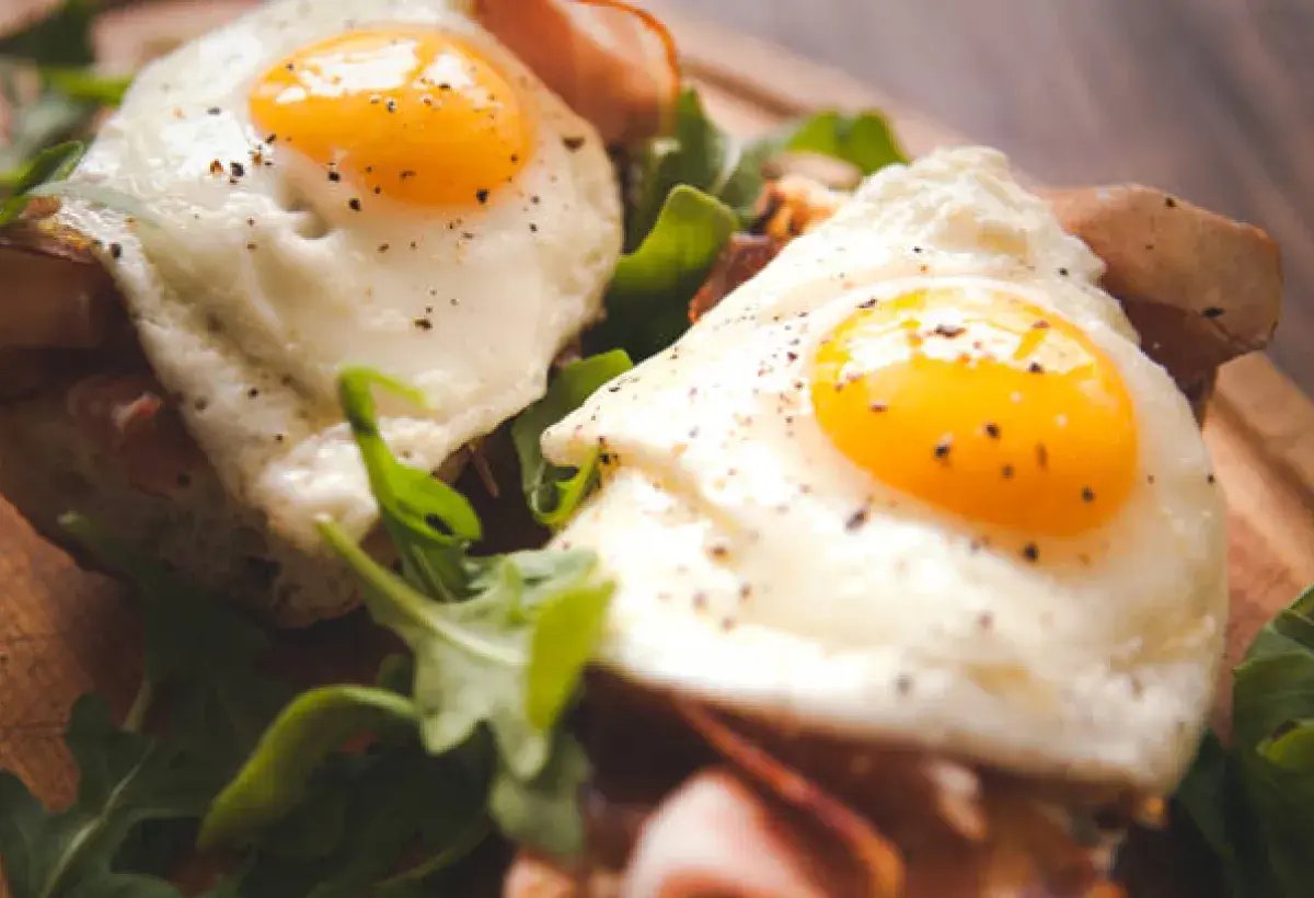 Sunnyside up eggs on salad