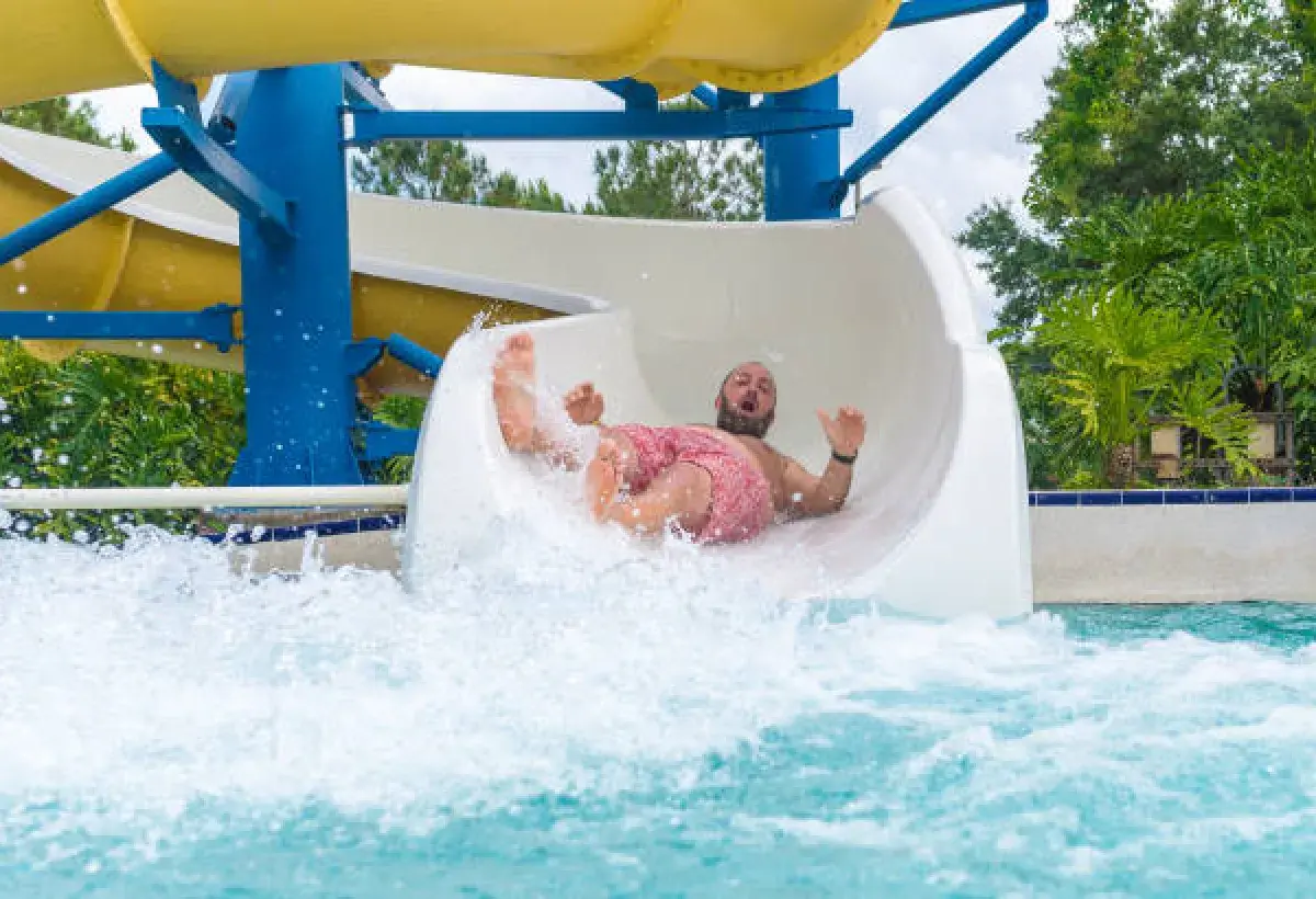 Water slide tester riding a large resort slide