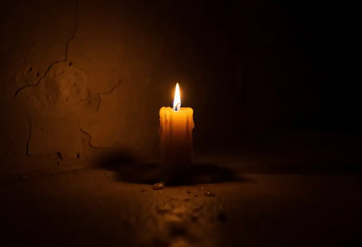  A single candle burning in a dark room