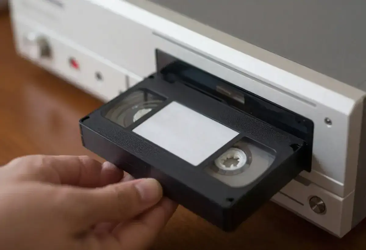 Classic VHS cassette tape being inserted into a home VCR