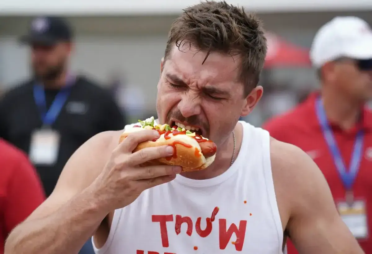 Competitive eater participating in a major hot dog eating contest