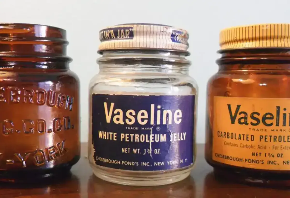 Display of antique Vaseline jars in a museum exhibit